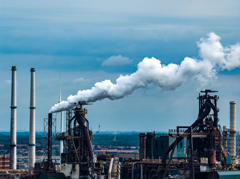 Aerial view of Tata Steel plant with industrial chimneys emitting smoke plumes over the manufacturing facility in Velsen Noord Noord Holland Netherlands. Aerial view of Tata Steel plant with industrial chimneys emitting smoke plumes over the manufacturing facility in Velsen Noord Noord Holland Netherlands.