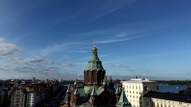 Aerial view of Uspenski Cathedral with its distinctive green domes and golden crosses rising above the historic cityscape and harbor of Helsinki Uusimaa Finland. Aerial view of Uspenski Cathedral with its distinctive green domes and golden crosses rising above the historic cityscape and harbor of Helsinki Uusimaa Finland.