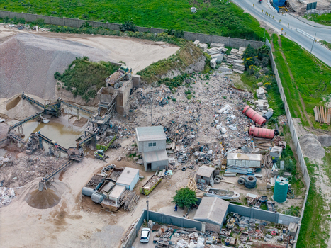 Aerial view of the industrial waste processing facility in Philippi featuring piles of gravel sorting machinery and debris in Cape Town Western Cape South Africa.
