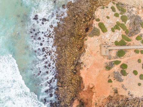 Aerial view of strong waves hitting the shore at Praia da Bordeira Carrapateira Portugal