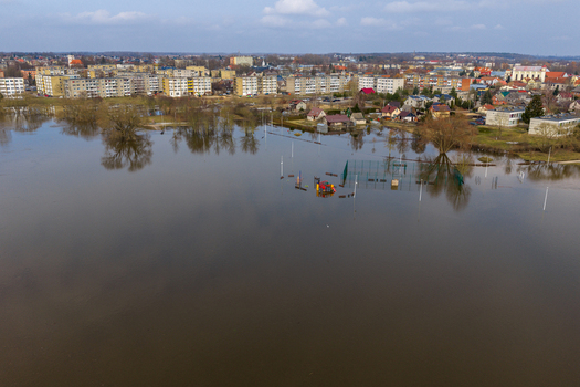 Aerial view of a flooded residential area with a submerged playground and apartment buildings under a cloudy sky in Kedainiai Kaunas County Lithuania. Aerial view of a flooded residential area with a submerged playground and apartment buildings under a cloudy sky in Kedainiai Kaunas County Lithuania.
