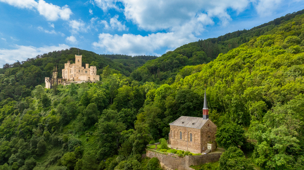 Aerial view of Stolzenfels Castle and its chapel nestled among lush green forests on a hillside under a cloudy blue sky Koblenz Rheinland Pfalz Germany. Aerial view of Stolzenfels Castle and its chapel nestled among lush green forests on a hillside under a cloudy blue sky Koblenz Rheinland Pfalz Germany.