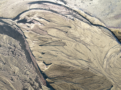 Aerial view of intricate sand patterns and riverbed textures formed by water flow in Poland. Aerial view of intricate sand patterns and riverbed textures formed by water flow in Poland.
