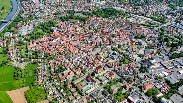 Aerial view of the historic old town of Forchheim featuring traditional red roofed architecture dense green trees and the Main Danube Canal Forchheim Bavaria Germany. Aerial view of the historic old town of Forchheim featuring traditional red roofed architecture dense green trees and the Main Danube Canal Forchheim Bavaria Germany.