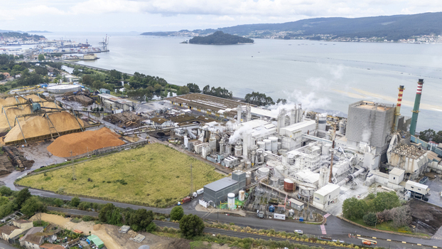 Aerial view of the Biofabrica de Ence pulp mill with its industrial structures and wood chip piles along the Ria de Pontevedra estuary Pontevedra Pontevedra Spain. Aerial view of the Biofabrica de Ence pulp mill with its industrial structures and wood chip piles along the Ria de Pontevedra estuary Pontevedra Pontevedra Spain.