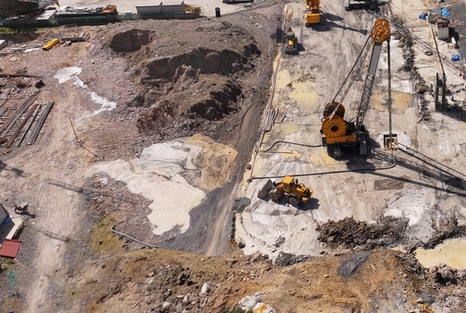 Aerial view of a busy construction site with heavy machinery excavators and cranes working on a large excavation project in Avcilar Istanbul Turkiye. Aerial view of a busy construction site with heavy machinery excavators and cranes working on a large excavation project in Avcilar Istanbul Turkiye.
