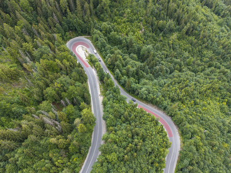 Aerial view of the winding Vernarske Chvalabohu road surrounded by dense green forest in Vernar Presovsky kraj Slovakia. Aerial view of the winding Vernarske Chvalabohu road surrounded by dense green forest in Vernar Presovsky kraj Slovakia.