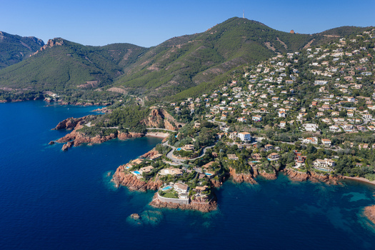 Aerial view of Le Trayas coastline featuring luxury villas nestled among rocky cliffs and lush greenery overlooking the Mediterranean sea in Saint Raphael Provence Alpes Cote d Azur France. Aerial view of Le Trayas coastline featuring luxury villas nestled among rocky cliffs and lush greenery overlooking the Mediterranean sea in Saint Raphael Provence Alpes Cote d Azur France.