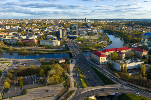 Vilnius County Lithuania 01 May 2026 Aerial view of the Neris river flowing through the city with the Gelezinis Vilkas Bridge and modern skyscrapers under a cloudy sky. Vilnius County Lithuania 01 May 2026 Aerial view of the Neris river flowing through the city with the Gelezinis Vilkas Bridge and modern skyscrapers under a cloudy sky.