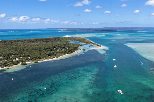 Aerial view of Moreton Island featuring turquoise waters sandbanks and boats near the coast of Kooringal Queensland Australia. Aerial view of Moreton Island featuring turquoise waters sandbanks and boats near the coast of Kooringal Queensland Australia.