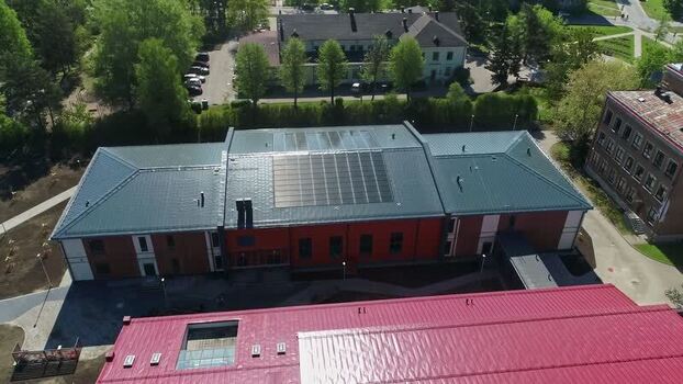 Aerial view of building with solar panels in Latvia.