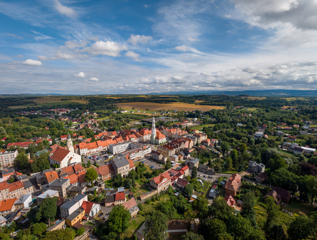 Aerial view of the historic town of Gryfow Slaski with red tiled rooftops church spires and green landscape under a blue sky in Gryfow Slaski Lower Silesian Voivodeship Poland. Aerial view of the historic town of Gryfow Slaski with red tiled rooftops church spires and green landscape under a blue sky in Gryfow Slaski Lower Silesian Voivodeship Poland.