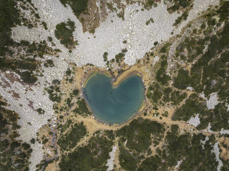 Aerial view of Muratovo Lake in Pirin National Park featuring its distinctive heart shaped shoreline surrounded by rugged rocky slopes and alpine vegetation in Blagoevgrad Province Bulgaria. Aerial view of Muratovo Lake in Pirin National Park featuring its distinctive heart shaped shoreline surrounded by rugged rocky slopes and alpine vegetation in Blagoevgrad Province Bulgaria.