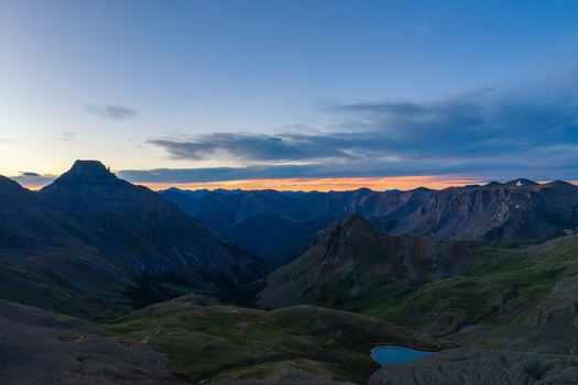Aerial view of Mount Sneffels and the rugged peaks of the San Juan Mountains at sunset featuring the alpine terrain of Yankee Boy Basin in Ouray County Colorado United States. Aerial view of Mount Sneffels and the rugged peaks of the San Juan Mountains at sunset featuring the alpine terrain of Yankee Boy Basin in Ouray County Colorado United States.