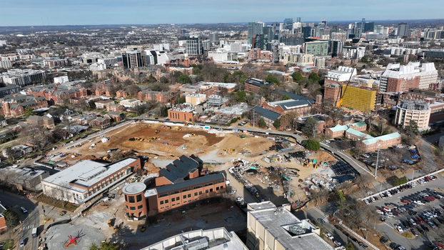 Aerial view of a large construction site with heavy machinery and excavation work in the foreground set against the urban skyline of Nashville Tennessee United States. Aerial view of a large construction site with heavy machinery and excavation work in the foreground set against the urban skyline of Nashville Tennessee United States.