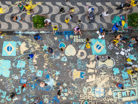 Rio de Janeiro Brazil 13 June 2026 Aerial view of people painting the street with Brazilian flags and football slogans on the asphalt next to the iconic wave patterned sidewalk.