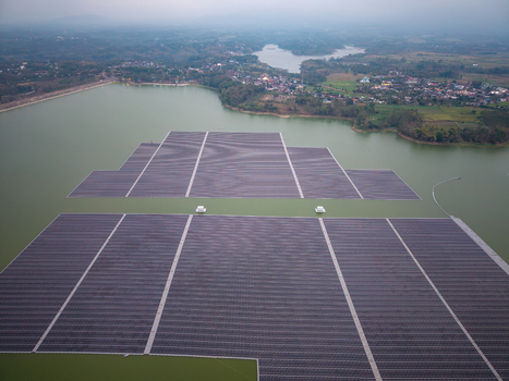 Aerial view of the floating solar farm on the Sutami Dam reservoir featuring extensive solar panel arrays on the water surface in Kecamatan Sumberpucung Jawa Timur Indonesia. Aerial view of the floating solar farm on the Sutami Dam reservoir featuring extensive solar panel arrays on the water surface in Kecamatan Sumberpucung Jawa Timur Indonesia.