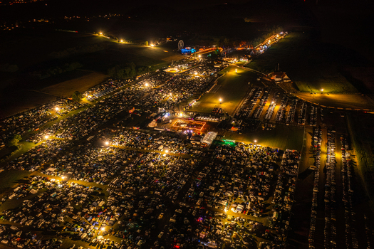 Aerial view of the Open Beatz Festival campsite at night with thousands of tents and cars illuminated by warm lights Herzogenaurach Bayern Germany. Aerial view of the Open Beatz Festival campsite at night with thousands of tents and cars illuminated by warm lights Herzogenaurach Bayern Germany.
