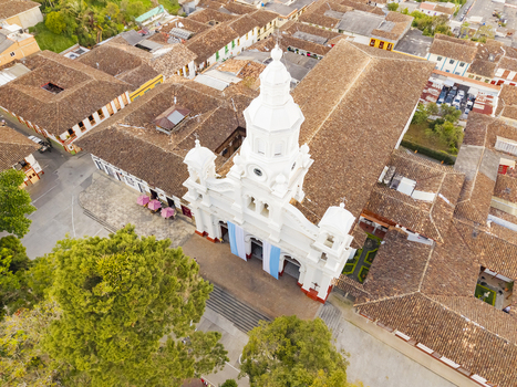 Aerial view of the majestic white church steeple rising amidst the terracotta rooftops a symphony of colonial architecture Salamina Caldas Colombia. Aerial view of the majestic white church steeple rising amidst the terracotta rooftops a symphony of colonial architecture Salamina Caldas Colombia.