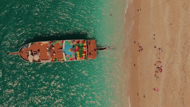 Aerial view of a tour boat anchored near a sandy beach Albania. Aerial view of a tour boat anchored near a sandy beach Albania.