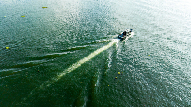 Rangamati Bangladesh 19 October 2022 Aerial view of a boat cruising across the calm waters of Kaptai Lake leaving a visible wake behind.
