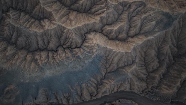 Aerial view of the rugged eroded landscape and deep ravines near Issyk Kul in the Issyk Kul Region Kyrgyzstan. Aerial view of the rugged eroded landscape and deep ravines near Issyk Kul in the Issyk Kul Region Kyrgyzstan.