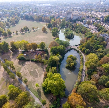 Aerial view of Clissold Park in Stoke Newington featuring its scenic ponds lush green spaces and surrounding urban residential area London England United Kingdom.