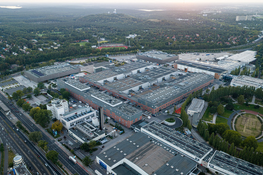 Aerial view of Messe Berlin exhibition grounds featuring large industrial halls flat rooftops and surrounding greenery in Berlin Berlin Germany. Aerial view of Messe Berlin exhibition grounds featuring large industrial halls flat rooftops and surrounding greenery in Berlin Berlin Germany.
