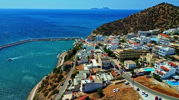 Aerial view of coastal town with harbor in Crete Greece.