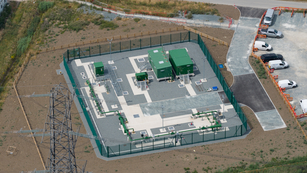 Aerial view of the Thurrock Flexible Generation Substation with green equipment containers electrical infrastructure and a perimeter fence in Tilbury England United Kingdom.