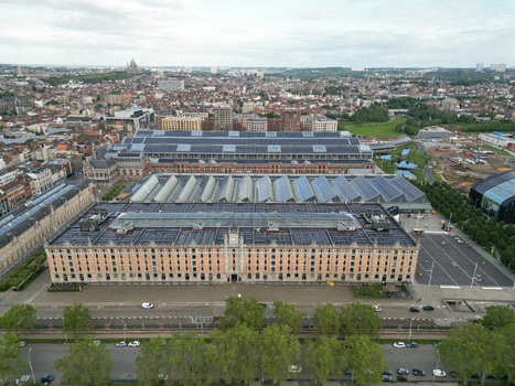 Aerial view of the historic Tour and Taxis site featuring the Entrepot Royal with its solar paneled roof and the surrounding urban landscape in Brussels Brussels Belgium.