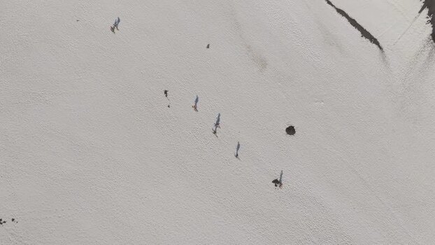 Aerial view of people walking on the snowy slopes of Mount Etna Italy. Aerial view of people walking on the snowy slopes of Mount Etna Italy.