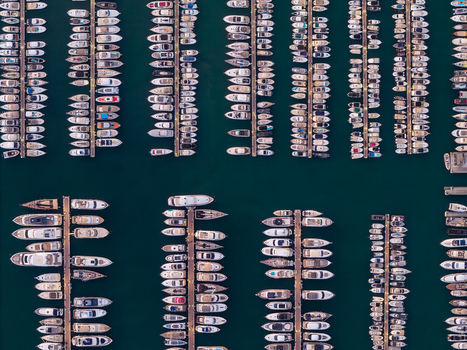 Aerial view of numerous yachts and boats docked in neat rows at the marina in Antibes Provence Alpes Cote d Azur France. Aerial view of numerous yachts and boats docked in neat rows at the marina in Antibes Provence Alpes Cote d Azur France.