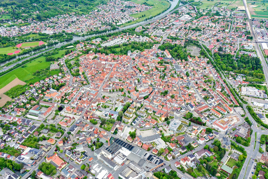 Aerial view of the historic old town of Forchheim with its dense red roofed buildings lush green parks and the Regnitz river in the background in Forchheim Bavaria Germany. Aerial view of the historic old town of Forchheim with its dense red roofed buildings lush green parks and the Regnitz river in the background in Forchheim Bavaria Germany.