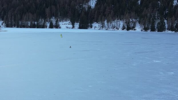Aerial view of kite surfer on frozen Reschensee Italy. Aerial view of kite surfer on frozen Reschensee Italy.
