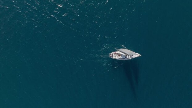 Aerial view of a boat cruising in Plemmirio Italy.