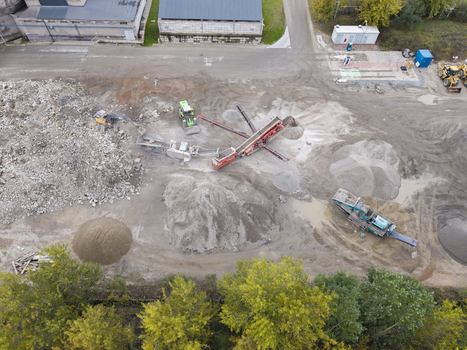 Aerial view of demolition and dismantling works with heavy machinery and piles of rubble at a construction site in Krakow Lesser Poland Voivode Poland.