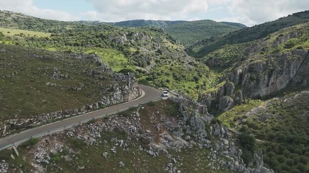 Aerial view of a winding road through a rocky canyon Spain.