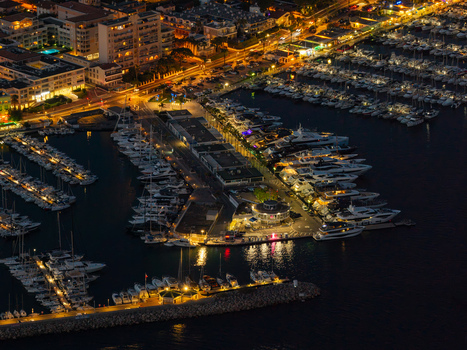 Aerial view of the illuminated Port Vauban in Antibes at night with luxury yachts docked in the marina city lights and harbor waters in Antibes Provence Alpes Cote d Azur France. Aerial view of the illuminated Port Vauban in Antibes at night with luxury yachts docked in the marina city lights and harbor waters in Antibes Provence Alpes Cote d Azur France.