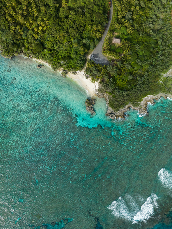 Aerial view of the vibrant turquoise waters meeting the lush green coastline a serene tropical escape Ouvéa Loyalty Islands Province New Caledonia. Aerial view of the vibrant turquoise waters meeting the lush green coastline a serene tropical escape Ouvéa Loyalty Islands Province New Caledonia.