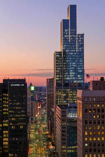 Detroit United States 09 March 2026 Aerial view of illuminated skyscrapers Hudsons Detroit new GM world head quarters and urban streets at sunset.