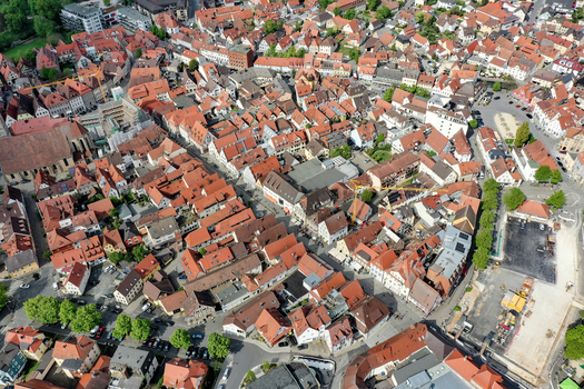 Aerial view of Hauptstrasse and the historic old town with red tiled roofs and a church in Forchheim Bayern Germany.