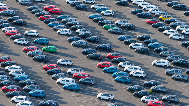 Lambres lez Douai France 07 July 2026 Aerial view of the AESC France facility parking lot filled with hundreds of new electric vehicles arranged in orderly diagonal rows.