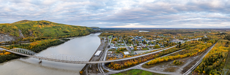 Aerial view of the Nenana Bridge spanning the Tanana River surrounded by autumn foliage and the town of Nenana Alaska United States. Aerial view of the Nenana Bridge spanning the Tanana River surrounded by autumn foliage and the town of Nenana Alaska United States.