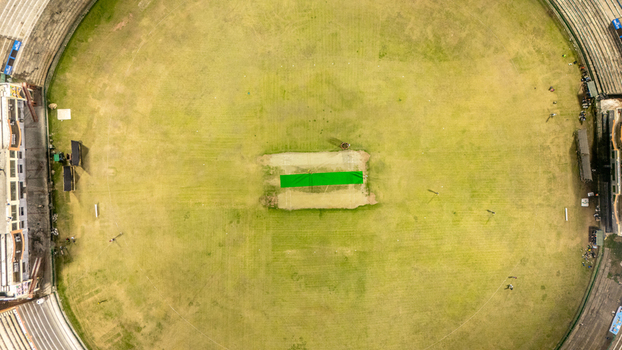 Aerial view of Muzaffarabad Cricket Stadium featuring the green pitch circular field and surrounding stands in Muzaffarabad Azad Kashmir Pakistan. Aerial view of Muzaffarabad Cricket Stadium featuring the green pitch circular field and surrounding stands in Muzaffarabad Azad Kashmir Pakistan.