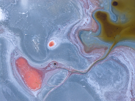 Aerial view of the colorful mineral deposits and salt crusts of Searles Lake with vibrant red and orange brine pools San Bernardino County California United States. Aerial view of the colorful mineral deposits and salt crusts of Searles Lake with vibrant red and orange brine pools San Bernardino County California United States.