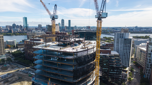 Aerial view of the construction site at Kendall Square with tall yellow cranes and steel framework of a new building Cambridge Massachusetts United States. Aerial view of the construction site at Kendall Square with tall yellow cranes and steel framework of a new building Cambridge Massachusetts United States.
