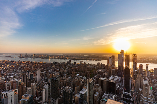 View of the New York City skyline at sunset with skyscrapers the Hudson River and golden light over the urban landscape in New York New York United States. View of the New York City skyline at sunset with skyscrapers the Hudson River and golden light over the urban landscape in New York New York United States.
