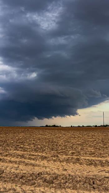 View of a vast plowed field under a dark stormy sky Latvia. View of a vast plowed field under a dark stormy sky Latvia.