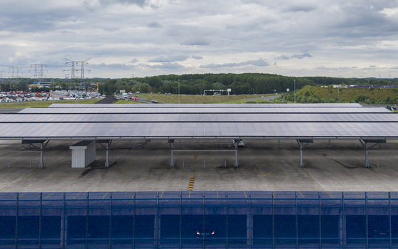 Aerial view of the large solar panel canopy covering the parking lot at IKEA Eindhoven with a highway and industrial landscape in the background in Son Noord Brabant Netherlands. Aerial view of the large solar panel canopy covering the parking lot at IKEA Eindhoven with a highway and industrial landscape in the background in Son Noord Brabant Netherlands.